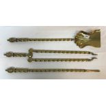 A set of three Victorian brass barley twist shafted fire irons with lidded urn shaped finials,