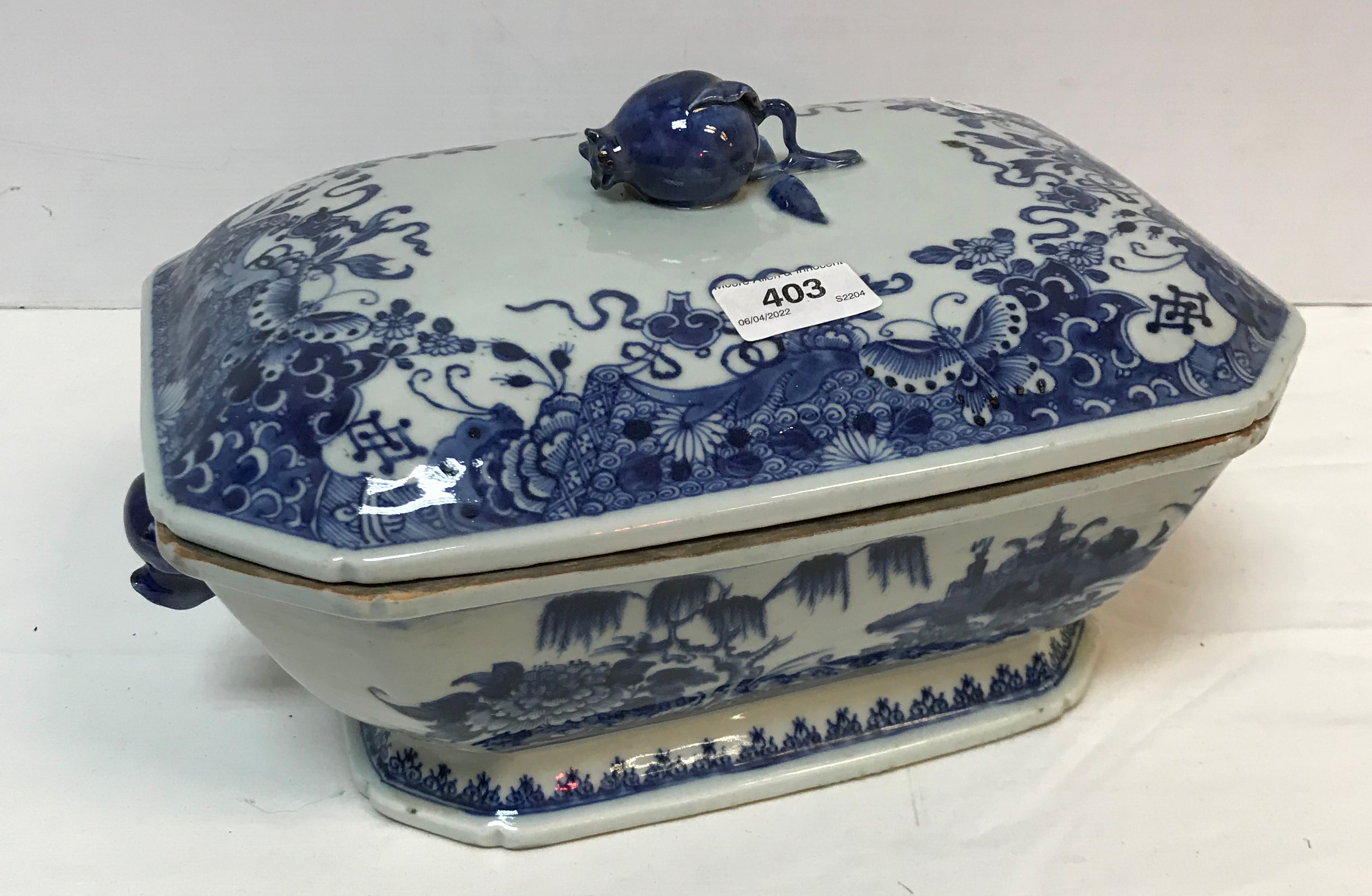 An 18th Century Chinese blue and white tureen and cover with pomegranate finial within a border of