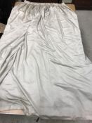A pair of sateen cream lined curtains with taped pencil pleat heading,