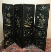 A 19th Century Chinese black lacquered framed four fold screen with silkwork panels,