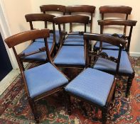 A set of six Victorian mahogany bar back dining chairs with foliate carved back rail above a