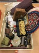 A box containing assorted sewing accoutrements to include an ebony pin cushion in the form of a