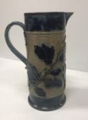 A Victorian glazed stoneware jug with holly decoration,