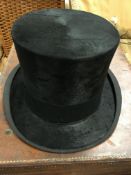 A black silk top hat by Gieves, Old Bond Street, London, inner circumference approx 21.75" or 8.