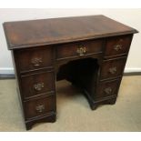 A figured mahogany kneehole desk in the George III taste,