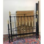 A Victorian style black painted and brass double bedstead with bobbin decorated column decoration