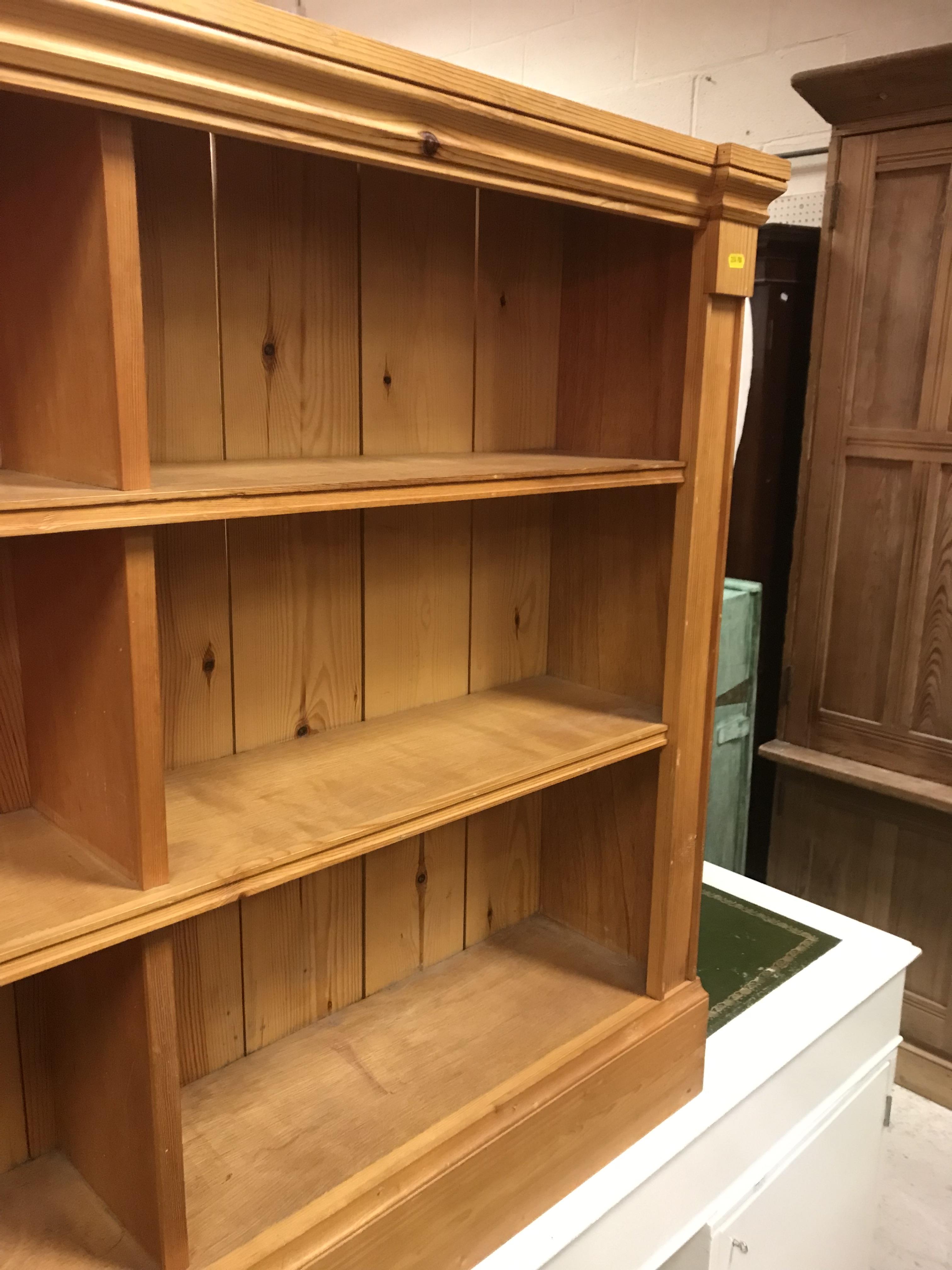 A pair of modern stained pine open bookcases of two banks of three shelves, raised on plinth bases, - Image 6 of 15
