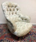 A Victorian button back salon chair upholstered in pink and green floral on cream ground raised on