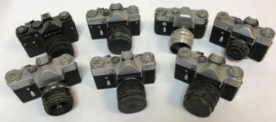 A collection of seven Zenit cameras including three Zenit-E, a Zenit B, EM,