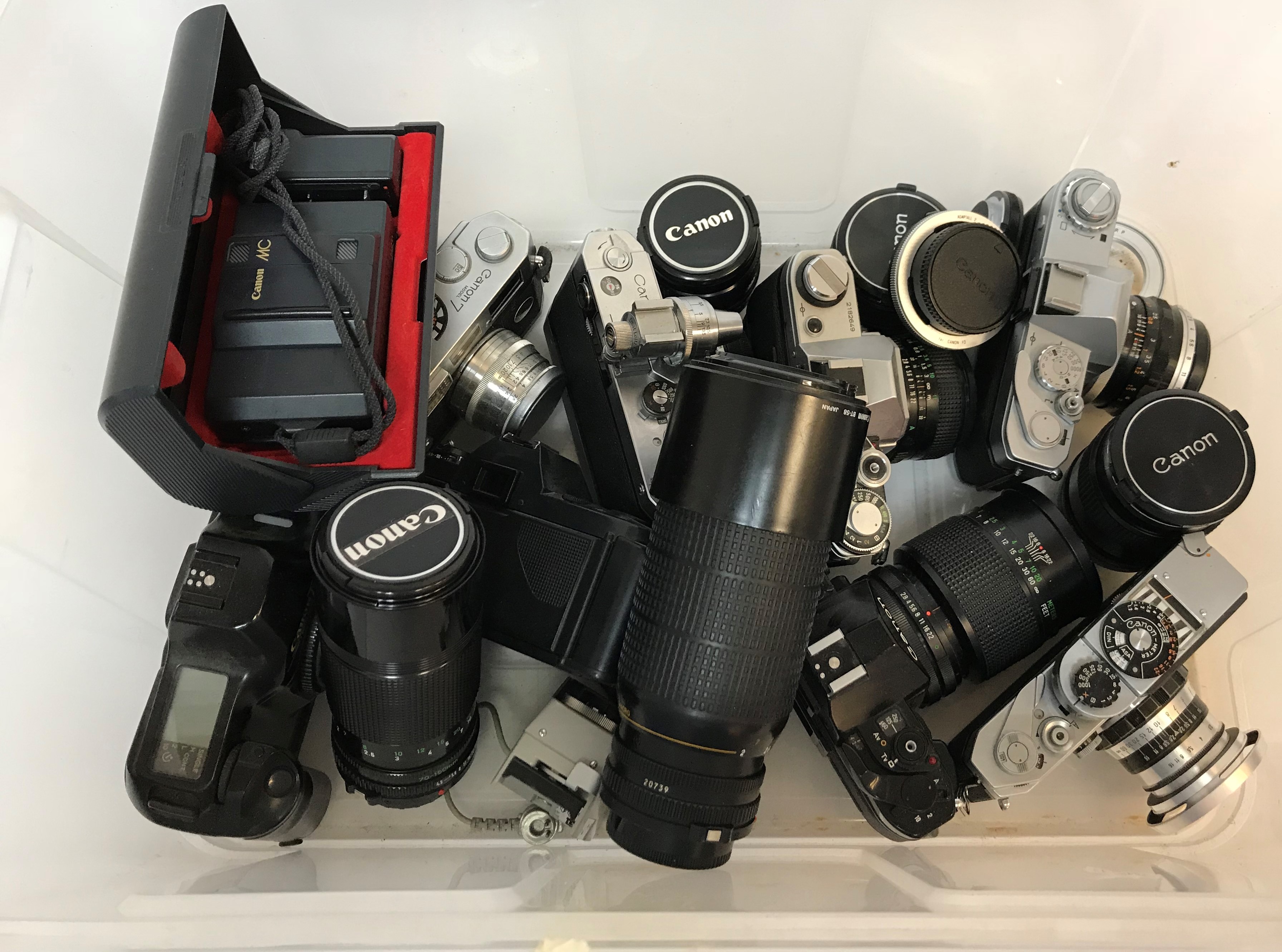 A collection of ten various Canon cameras including a Model VT, Model 7 AE-1, Pellix QL, A1, T50,