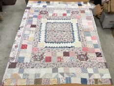 A 19th Century patchwork quilt in pink, blue and white,