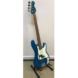 A Jim Deacon electric blue bodied bass guitar together with ABC Music soft case