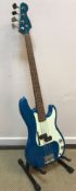 A Jim Deacon electric blue bodied bass guitar together with ABC Music soft case