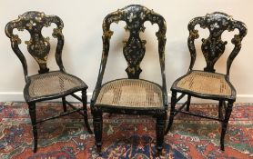 A pair of Victorian black lacquered mother of pearl inlaid and gilded salon chairs,