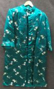 A 20th Century Chinese brocade jade green silk jacket with frog fastenings and chrysanthemum and