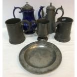 A collection of various pewter wares to include Victorian quart mug,