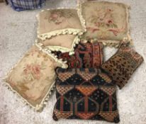 A box containing assorted scatter cushions to include two carpet examples,