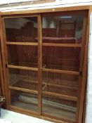 A pair of modern teak bookcase cabinets