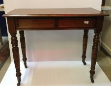 A mahogany two drawer side table in the