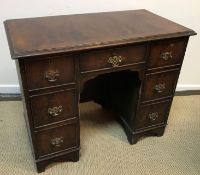 A figured mahogany kneehole desk in the