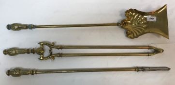 A set of three brass fire irons with fla