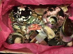 A box containing various costume jewelle