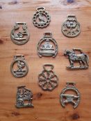 Collection of 28 vintage horse brasses and ornate letter opener and magnifying glass. Donated by