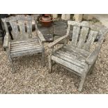 A pair of teak garden chairs