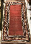 An old Kelim carpet, the central panel of plain red,