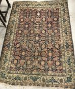 A Tabriz rug, the central panel set with repeating floral motifs on a navy ground,