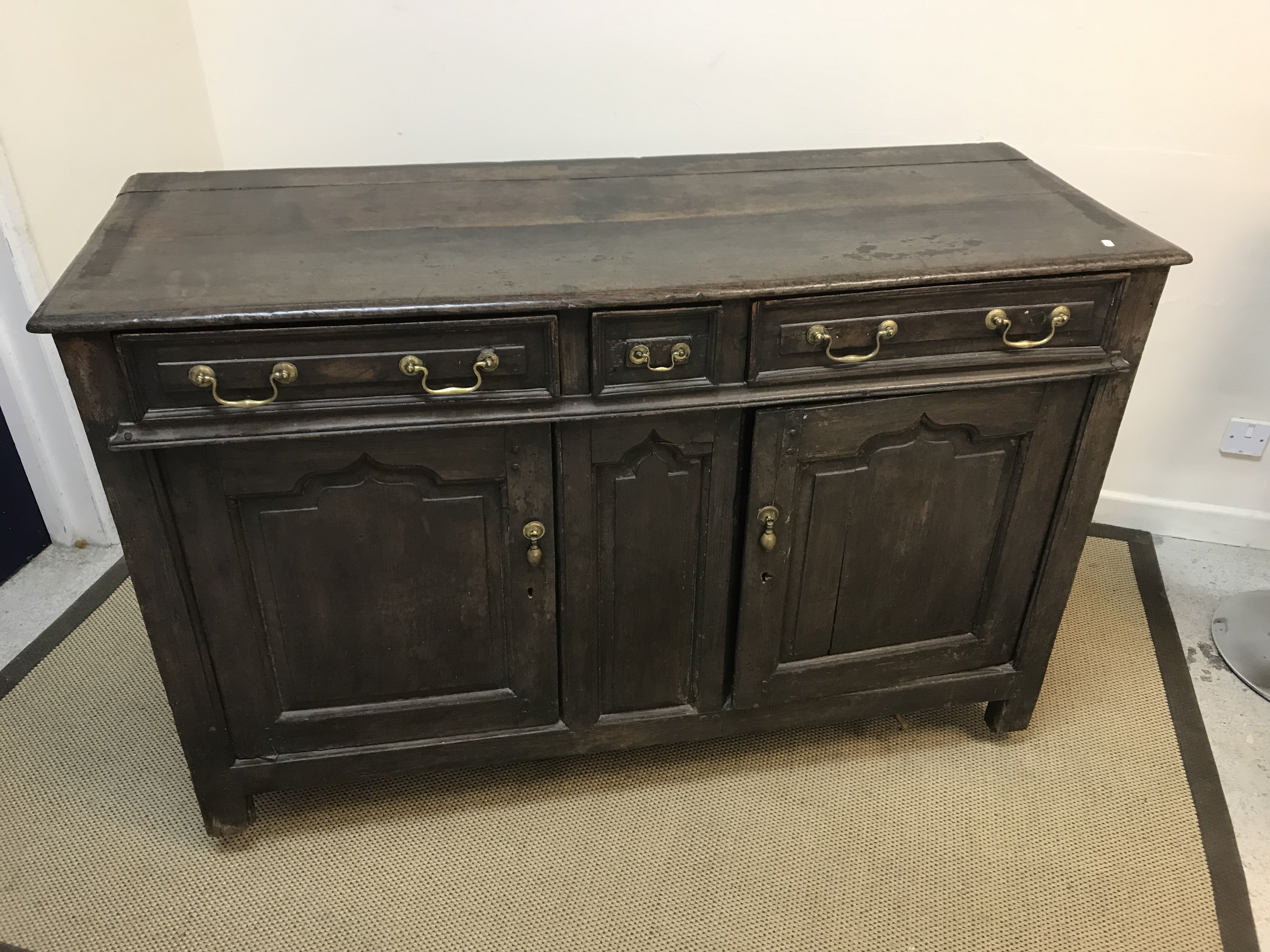 An early 18th Century oak enclosed dresser,