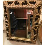 A 19th Century carved giltwood and gesso framed wall mirror in the Florentine taste with all over