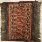 A vintage Afshar tribal rug, the central panel set with repeating hook motifs on a red ground,