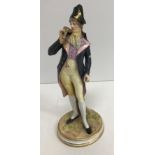 A late 19th Century Meissen figure of "A gallant standing by tree stump in 18th Century dress",