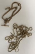 A collection of 4 various 9 carat gold chains to include watch chain with fob and T bar,