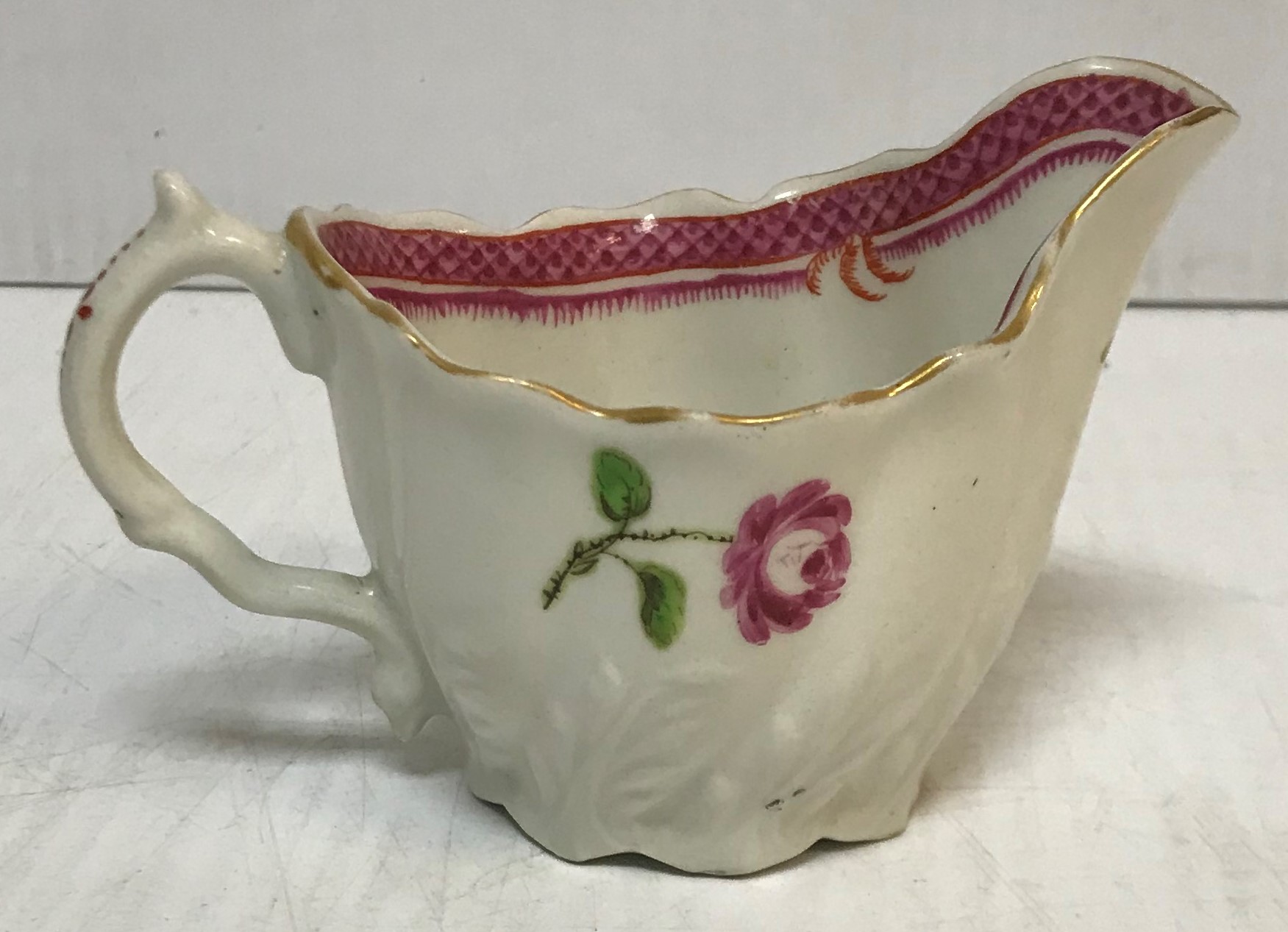 An 18th Century silver shaped Chelsea type cream jug with relief work foliate decoration and floral - Image 2 of 30