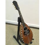 A Marco Rebora of Napoli mandolin with rosewood and satinwood strung back and mother of pearl