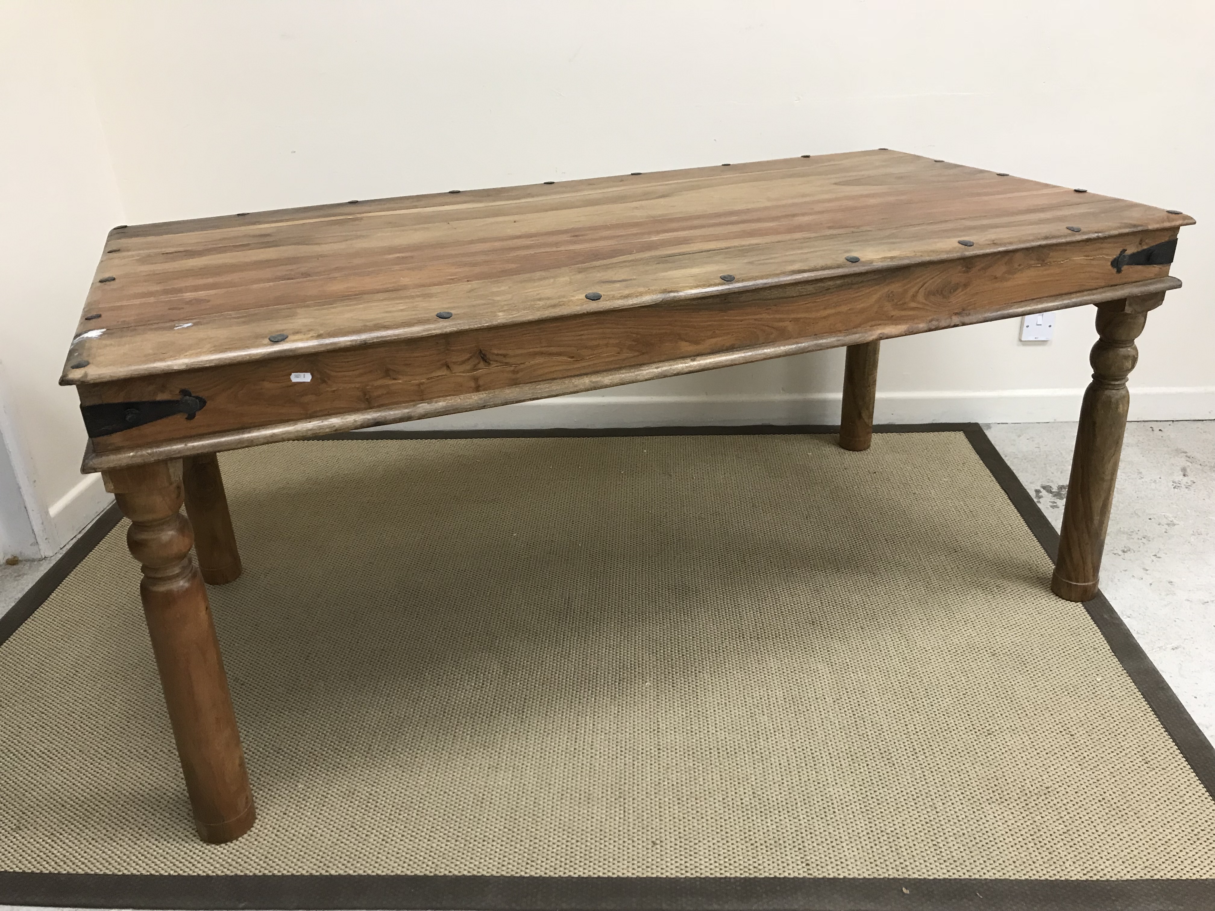 An Indian hardwood and studded dining table, the plank top over a plain frieze, - Image 2 of 2