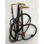A collection of four antler handled riding crops each with metal ferrule and leather shaft and