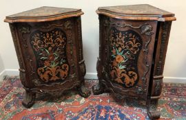 A pair of Continental walnut and marquetry inlaid serpentine fronted corner cupboards,