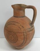 A Cypriot Iron Age terracotta flagon with geometric black line decoration,