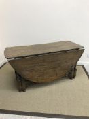 An oak oval gate-leg drop-leaf dining table in the 17th Century style,