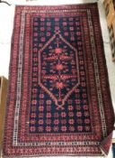 A Turkaman rug, the central panel set with lozenge shaped medallion on a navy ground,