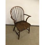 A 19th Century fruitwood and elm stick back elbow chair,