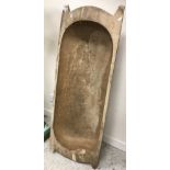A large single piece carved wooden trug,