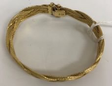 An 18 carat gold bracelet of woven form,