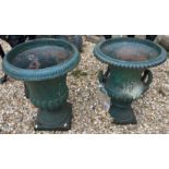Two similar green cast iron garden urns CONDITION REPORTS Some areas of rusting,