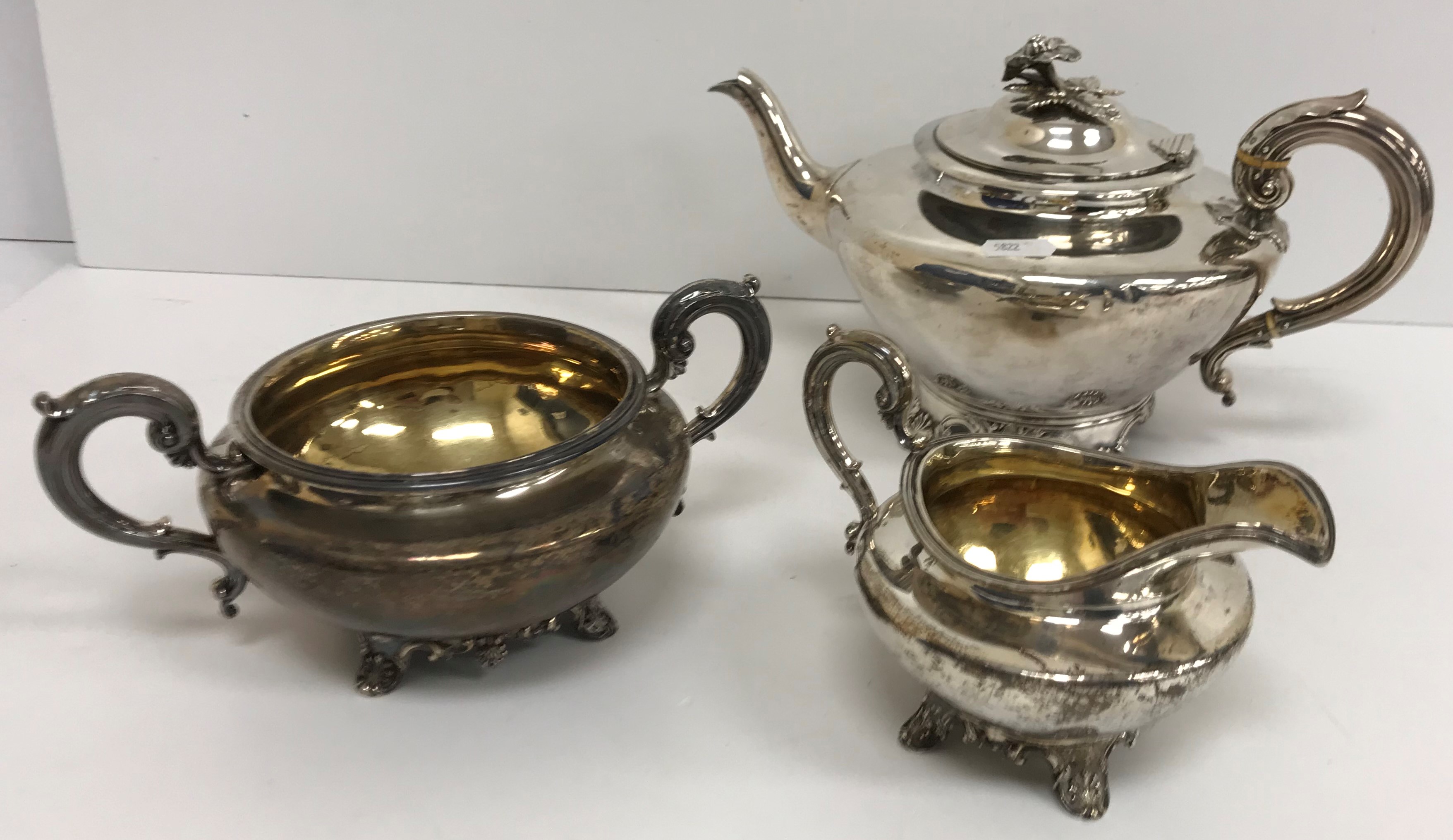 A William IV silver teapot with flower set finial, raised on four shell feet (Charles Fox II,