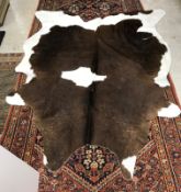 Taxidermy - A cow hide rug 241 cm x 189 cm bears label verso inscribed "Black and white cow hide