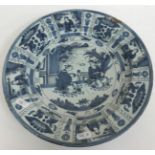 A collection of 18th Century Delft plates including a Kraak style shallow dish with figural panel
